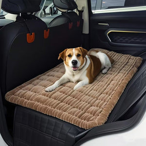 Dog lying on a brown pet seat cover in a car